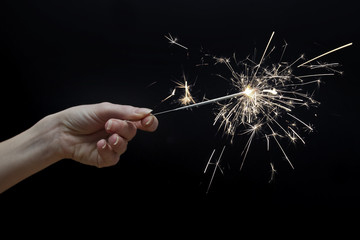 woman's hand holding a sparkler