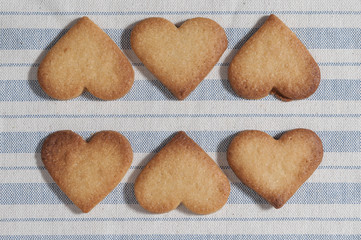 Butter cookies, heart shaped, on a striped fabric napkin