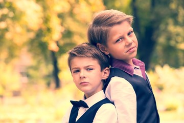 Fototapeta premium Portrait of a boy on a background of green nature