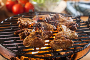 Grilling chicken wings on barbecue grill