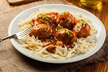 Pasta fettuccine and meatballs with tomato sauce