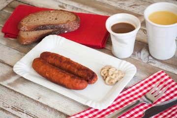 Bratwurst with mustard for breakfast, with drinks