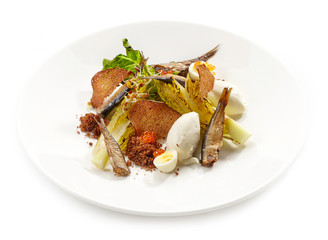 plate of salad with sprats and sour cream