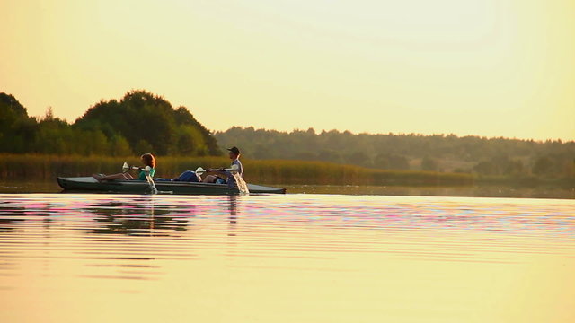 Man and woman paddling boat synchronously. Team-building, sport