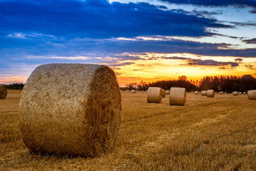 End of day over field with hay bale