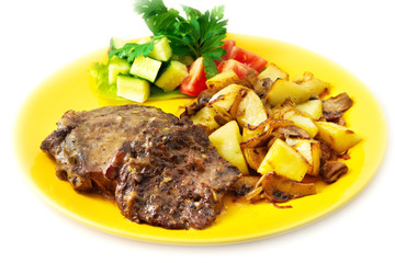 the roasted lamb with potatoes on the yellow plate