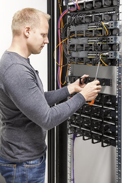 IT engineer builds network rack in datacenter