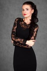 Portrait of a young attractive woman in a black evening dress