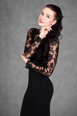Fototapeta premium Portrait of a young attractive woman in a black evening dress