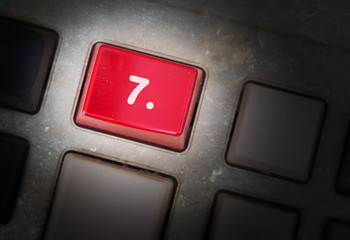 Red button on a dirty old panel