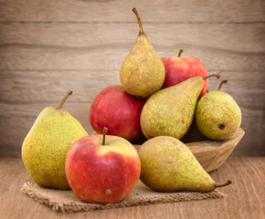 Pears and apples on wood table