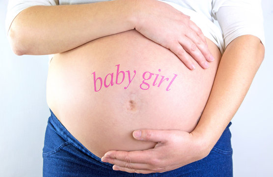Pregnant woman belly with "baby girl" text