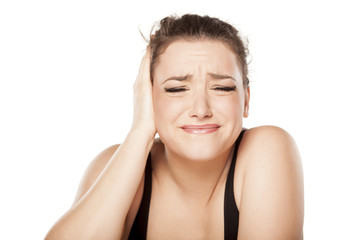 unhappy young woman has pain in the ear