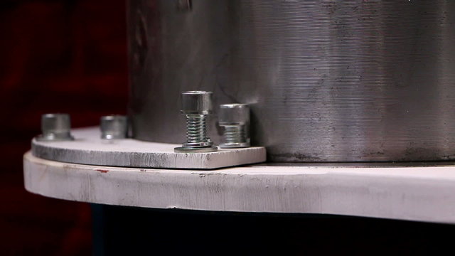 Man tightening a bolt using a screwdriver