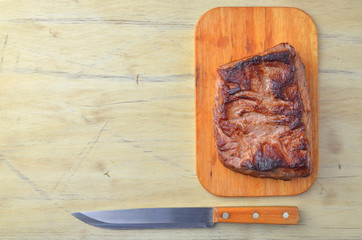 Roast beef on cutting board on a wooden table