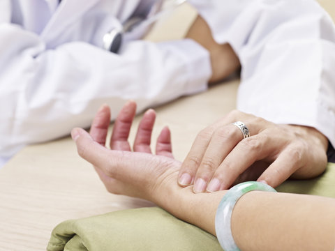 Doctor Taking Pulse Of A Patient