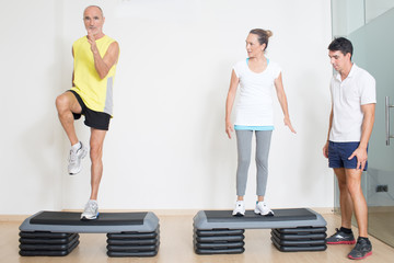 Fototapeta premium Trainer hilft Senioren beim step training