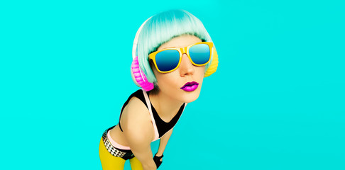 Glamorous party dj girl in bright clothes on a blue background l