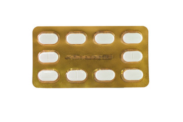 White tablet in gold blister pack