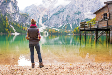 Full length portrait of young woman on lake braies in italy
