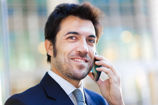 Handsome businessman talking on the mobile phone