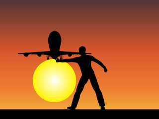 Man silhouette with plane at sunset