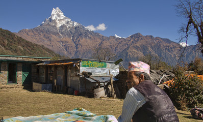 nepali guide and in the background mount machapuchare