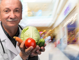 Senior male doctor holding vegetables