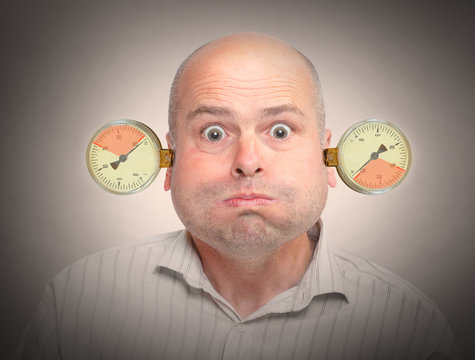 Stressed and overworked businessman under pressure.