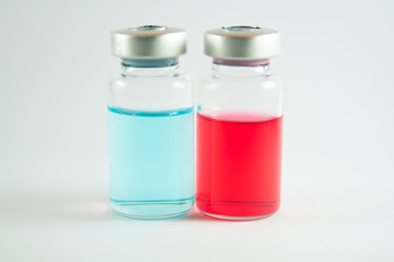 Red and blue liquid in injection vials