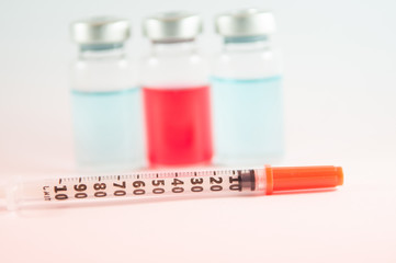 Red and blue liquid in injection vials