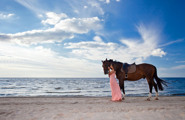 beautiful girl with horse on seacoast