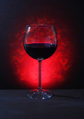Glass of Red Wine with Lights Background