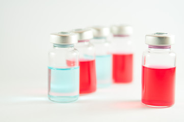 Red and blue liquid in injection vials