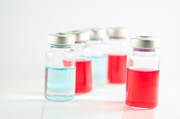 Red and blue liquid in injection vials