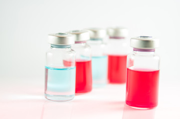 Red and blue liquid in injection vials