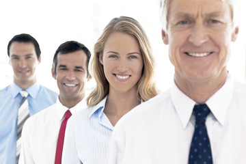 Portait of a business team. Selective focus on the young beautiful woman.