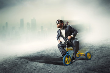 Nerdy businessman riding a small bicycle