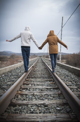 Young couple walking on a railway. Rural setting - 75278618