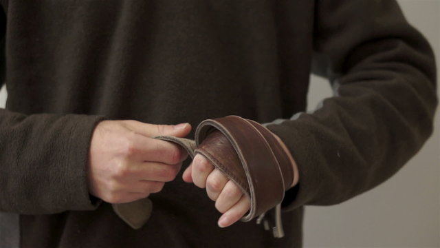Man Wrapping His Knuckles With Belt