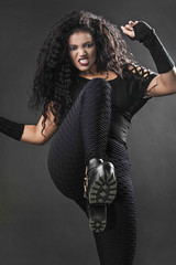 Angry and transgressive rocker girl kicking