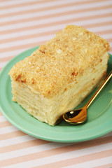 Napoleon cake on plate on table close-up