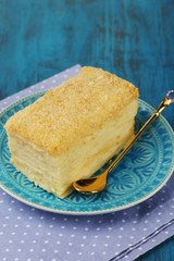 Napoleon cake on plate on table close-up