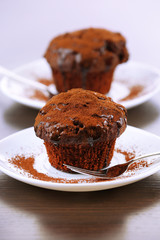 Yummy chocolate cupcake on table