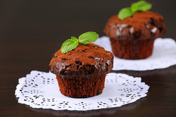Yummy chocolate cupcake on table