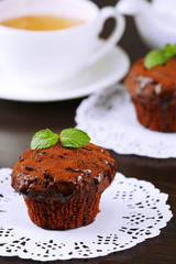 Yummy chocolate cupcake on table