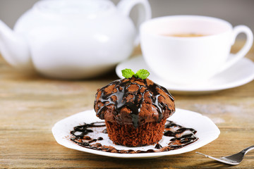 Yummy chocolate cupcake on table