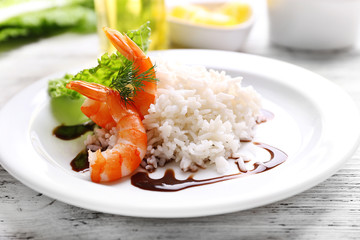 Boiled rice with shrimps served on table, close-up