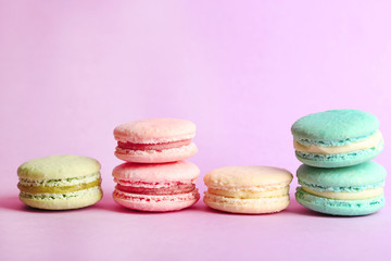 Assortment of gentle colorful macaroons on color background