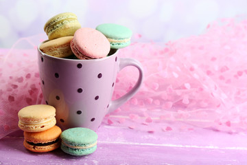 Assortment of gentle colorful macaroons in colorful mug